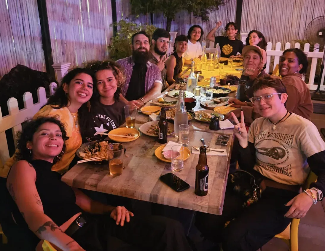 Panas sharing a meal at a long community table